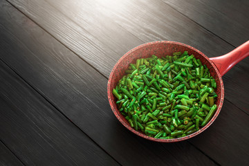 Pod beans in a frying pan with sunlight. A recipe for healthy eating