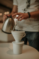 close up of hands holding cup