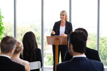 Senior businesswoman coach speaker giving a presentation in conference at team meeting workshop. coach mentor teacher concept