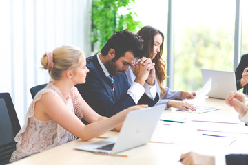 The supervisor blamed the intern for the wrong job at the meeting. Young people work in modern office. Professional business team success.