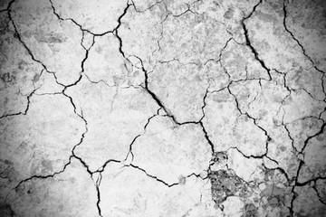 Cracks grunge texture earth background. Abstract dirty poster for design. Black and white image.