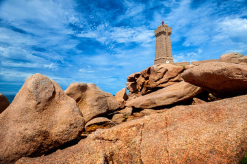 Ploumanac'h Mean Ruz lighthouse between the rocks in pink granite coast, Perros Guirec, Brittany, France.