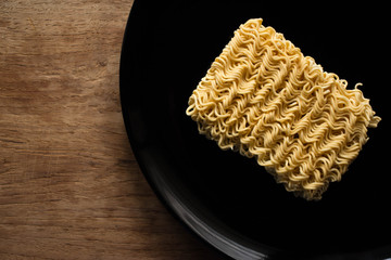 Instant noodles or dry noodles circle isolated on a black background.