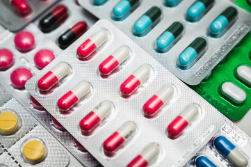 A lot of Colorful Medicine pills, tablets and capsules in packaging.