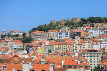 Buildings with orange roofs with mountains in the background