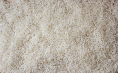 Close up of grains of jasmine rice, white long rise. White long grain rice, background image.