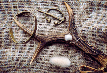 Viking era concept. Various old viking style objects on burlap textile cloth. Brooch, bracelet,...