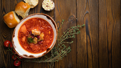 Ukrainian borsch with donuts, tomatoes and garlic