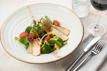 Beautiful salad on a white dish and a white background