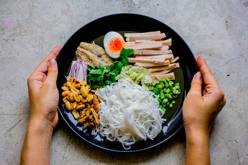 Rice vermicelli spicy salad Thai food. Rice Vermicelli Salad in the black round plate Traditional Southeast Asian cuisine. 