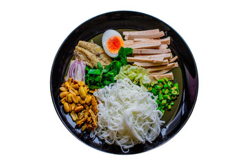 Rice vermicelli spicy salad Thai food on white background. Rice Vermicelli Salad in the black round plate Traditional Southeast Asian cuisine. 