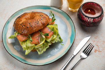 Burger sandwich with salmon, cream cheese, salad.