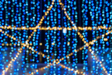 Bokeh LED lighting Orange star and blue hang, Blurred small light bulb background colorful
