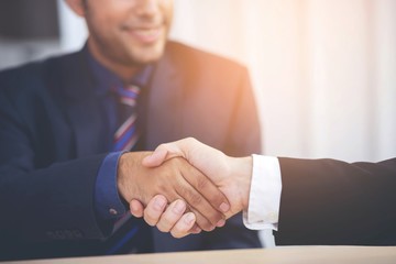 Good deal arriving for a job interview. Close up of two business people handshake man partnership...