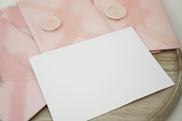 Fototapeta premium Gift certificates in a pink envelope. Wedding invitation or Valentine's Day cards - Mocap - place for text