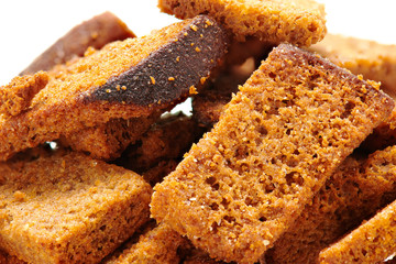 rye crackers, small dried pieces of bread with spices, delicious fast food isolated on white background