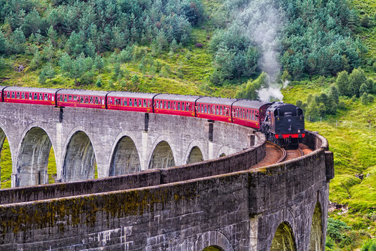 Glenfinnan Railway Viaduct in Scotland with the Jacobite steam train passing over. United Kingdom