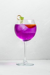 Unusual purple alcoholic cocktail in a wine glass