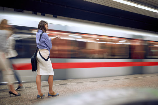 Businesswoman In Subway Looking At Her Wrist Watch. Time Goes By Fast Concept