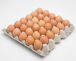 Eggs in paper tray isolated on white