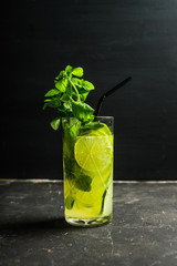Mojito cocktail with lime and mint on the rustic background. Selective focus. Shallow depth of field.