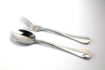 Spoon and spoon sparring on the white ground