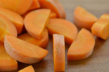 Cut carrots thick on wooden background