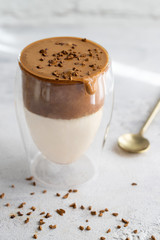 Dalgona coffee in crustal glass on the table at the morning with sunlight.