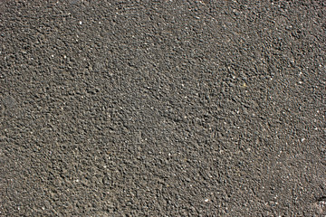 A macadamized road surface pavement texture dark grey background