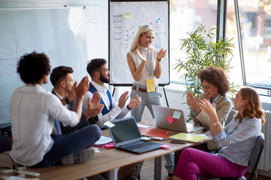 Coworkers applauding a colleague. Applause at a business meeting.