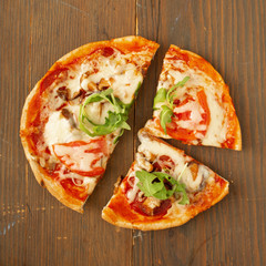 All dressed pizza with basil, herbs and tomato