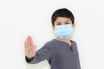 Covid-19 coronavirus barrier gesture well-protected and self-confident child who is not afraid to face the epidemic