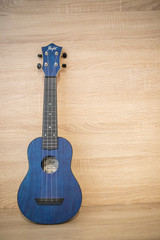 acoustic ukulele on wooden background