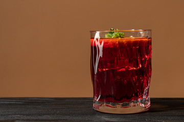 Glass of rum on the wooden table, Cuba Libre or long island iced tea cocktail with strong drinks and sliced orange