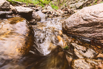 Clear freshwater, forest rocky creek, spring day in nature