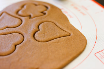 Christmas joy of cutting out cookies out of gingerbread dough, with a variety of decorative cutters