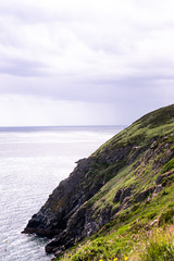 Photo of a green landscape with the sea in Howth, Ireland. 