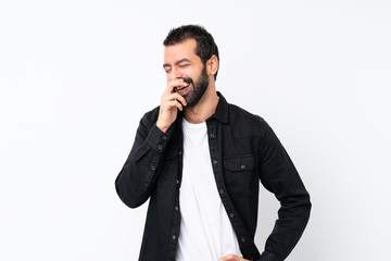 Young man with beard over isolated white background smiling a lot