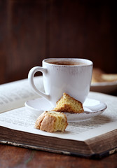 Cup of coffee with cantuccini (Italian cookies) on rustic wooden background.	
