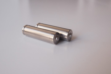 Two aa gray batteries on a white background