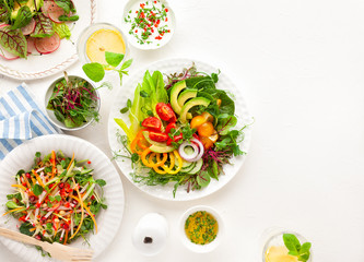 Various healthy salads of fresh vegetables,fruits and microgreens on table. Clean eating, lunch bowl. Top view. Concept taste of home meal.
