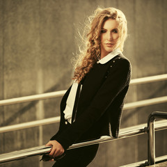 Young fashion blonde business woman in black jacket