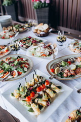 A festive table awaits guests. A variety of salads and cold dishes.