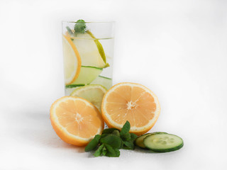 Chilled summer cocktail lemonade in a glass cup with ice, lemon, fresh cucumber and mint leaves. homemade lemonade to quench your thirst in the heat. selective focus.