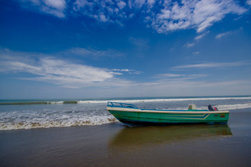 Naklejka na ściany i meble SAME, ECUADOR - MAY 06 2016: Fishing boat on the beach in the sand in a beautiful day in with sunny weather, blue sky in Same, Ecuador