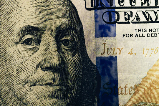 Macro close up of Ben Franklin's face on the US 100 dollar bill. Dollars Closeup Concept. American Dollars Cash Money