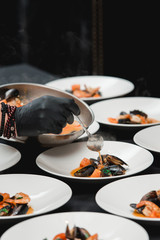Chief in a restaurant cooking seafood with sauce