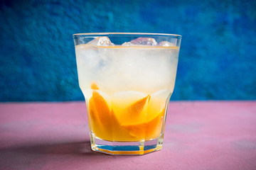 Old fashioned beverage with orange slices on rustic background. Selective focus. Shallow depth of field.
