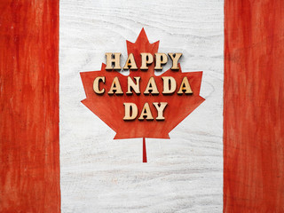 Fototapeta na wymiar Canadian Flag. Beautiful greeting card. Close-up, view from above. National holiday concept. Congratulations for family, relatives, friends and colleagues