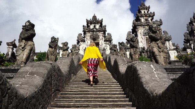 young woman walking up to temple